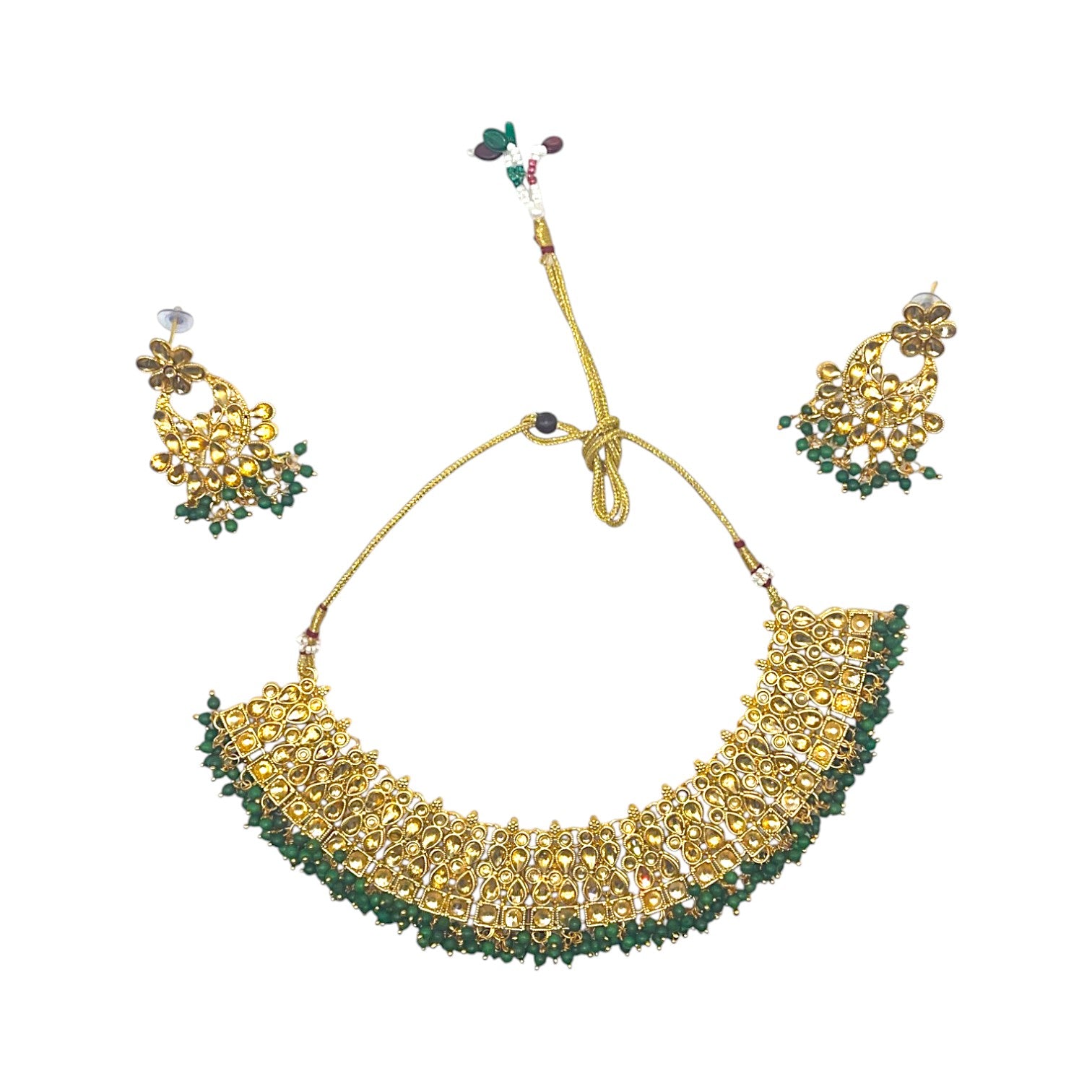Kundan Emerald Whisper Jewelry Set – Artificial gold-tone necklace and earrings featuring emerald stones and Kundan detailing.